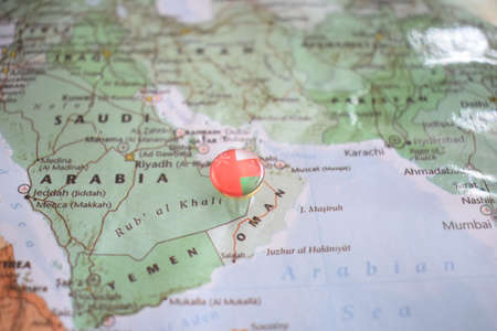Oman flag drawing pin on the map. High quality photoの写真素材