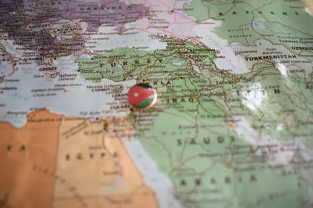 Jordan flag drawing pin on the map. High quality photo