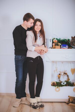 couple man and woman hugging  near the Christmas treeの写真素材