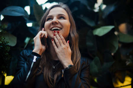 Young attractive girl talking by mobile phoneの写真素材