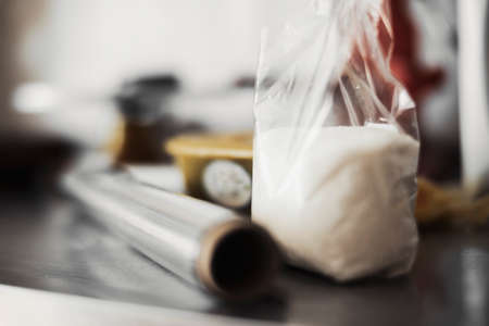 Close up of sugar and polyethylene plastic wrap.