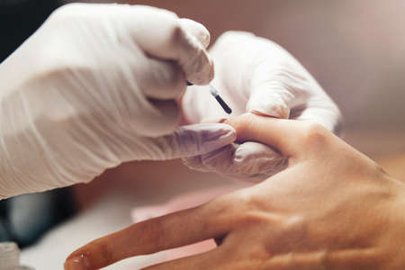 Closeup shot of a woman receiving a manicure by a beautician.の写真素材