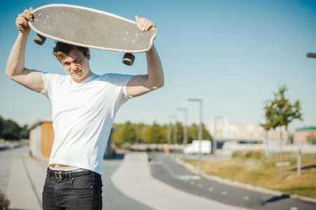 Young attractive man holding longboard.の写真素材