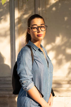 Young attractive bespectacled woman looking at the camera and smiling.の写真素材