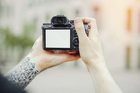 Close up of man hands holding cameraの写真素材