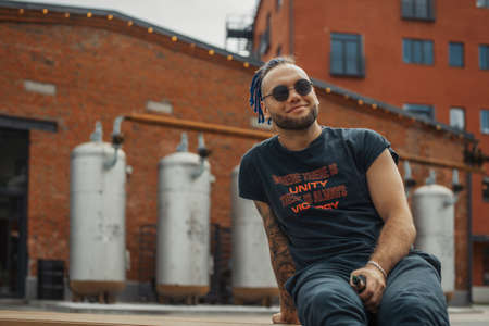 Portrait of young vaping man with dreadlocks. Vapor concept. Vaping e-Cigaretteの写真素材