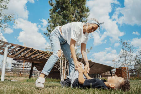 Attractive mum having fun with her sons at green park. Happy family concept.の写真素材