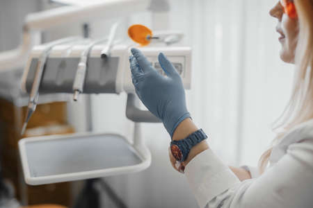 Close up of woman dentist checking dental equipment, dental instruments.