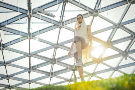 Attractive athletic man practicing yoga and warming up outdoorsの写真素材