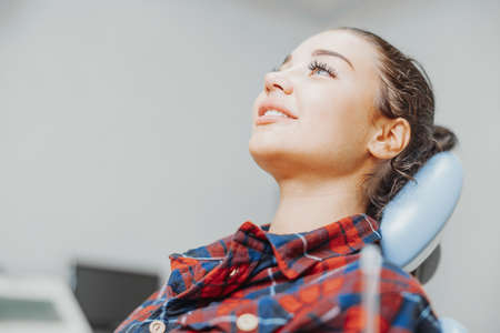 Close up of client smiling while waiting for a stomatologist at dental office.の写真素材
