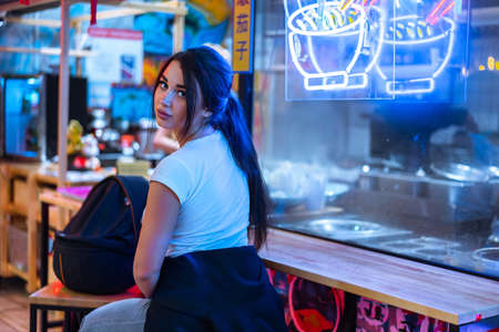 Close up of pretty woman in cafe of asian cuisine looking aside and smiling.の写真素材