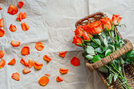 Flatlay of roses and petals on craft wrapping paper background. Summer or spring time. International women day. Copy space. Empty space.の写真素材