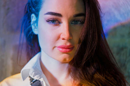 Young beautiful woman standing under bright multicoloured light in ancient church. Europe. Montenegro. Concept of travelling and bloggering.の写真素材