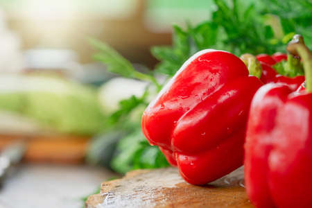Fresh red pepper with green and vegetables on wooden table at farm. Countryside organic food concept. Vegetarian.の写真素材
