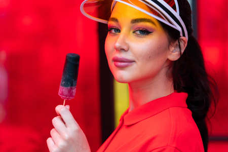 Close up of Young sexy brunette woman eating ice cream at sunny hot day. Having fun. seductive...
