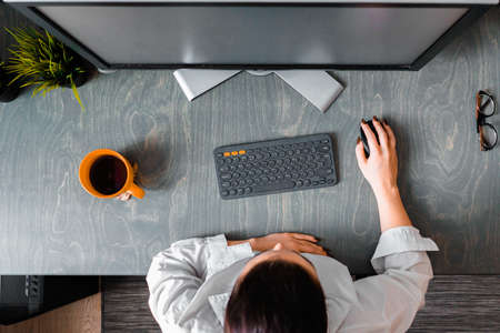 Woman working on PC in modern apartments. Freelance concept. Home office. Young successful entrepreneur. Comfortable working placeの写真素材