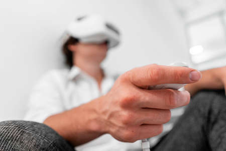 Man wearing virtual reality goggles in modern bright co-working office. the VR experience.