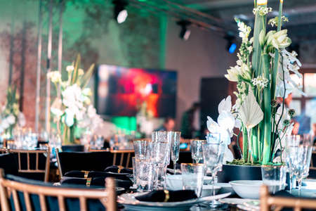 Luxury catering and service. Wedding or anniversary. Banquet. table served with cutlery, flowers, crockery and tablecloth.の写真素材