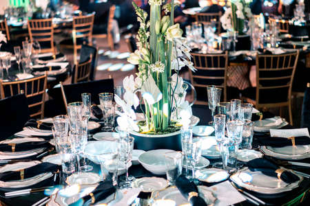 Luxury catering and service. Wedding or anniversary. Banquet. table served with cutlery, flowers, crockery and tablecloth.の写真素材
