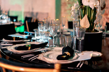 Luxury catering and service. Wedding or anniversary. Banquet. table served with cutlery, flowers, crockery and tablecloth.の写真素材