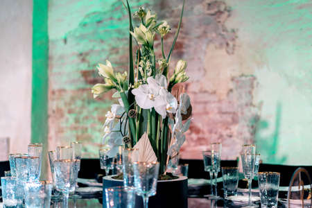 Luxury catering and service. Wedding or anniversary. Banquet. table served with cutlery, flowers, crockery and tablecloth.の写真素材