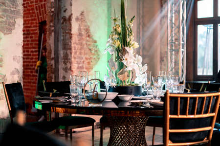 Luxury catering and service. Wedding or anniversary. Banquet. table served with cutlery, flowers, crockery and tablecloth.の写真素材