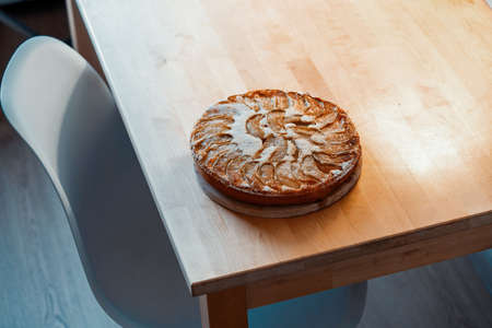 Freshly baked homemade apple pie on wooden table. Minimalism. Side view.の写真素材