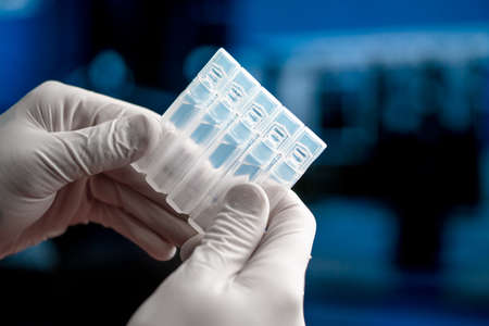 Doctor Or Researcher Holding Vaccine For Injection From SARS Coronavirus, 2019-nCoV. Vaccine Research and Medicine Clinical Trial In Modern Laboratoryの写真素材