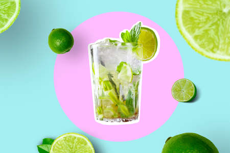 Creative Collage Of Glass With Mojito With Lime Slices And Limes on Bright Pink and Vivid Blue Geometric Abstract Backgroundの写真素材