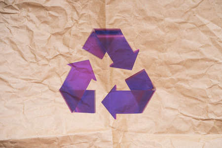 Violet Transparent Stylish Recycle Arrow on Biodegradable Paper Background. Reuse Sign. Eco Friendly and Environment Care Conceptの写真素材