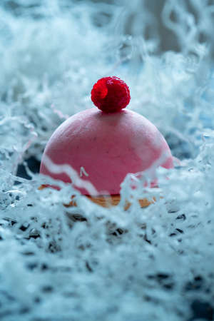 Berry Dessert With Crust And Raspberry Yogurt Mousse Tart Decorated by Fresh Delicious Raspberrry on Light Plums Background.の写真素材