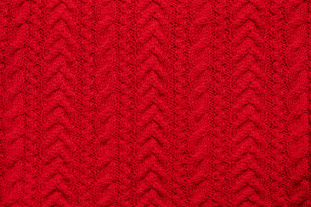 Red knitted textured sweater pattern.