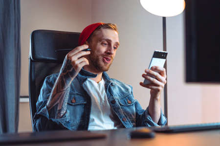 Creative Designer Holding Mobile Phone And Talking Via Video Call, Online Meeting and Conferenceの写真素材