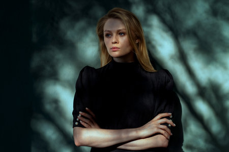 Dramatic Portrait Of Beautiful Woman With Trees Shadows At Her Face And Background.の写真素材