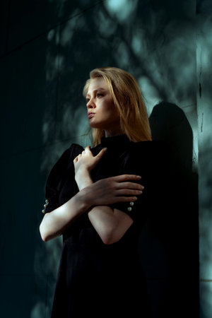 Dramatic Portrait Of Beautiful Elegant Lady With Trees Shadows At Her Face And Background. Surrealism And Mystecism Conceptの写真素材