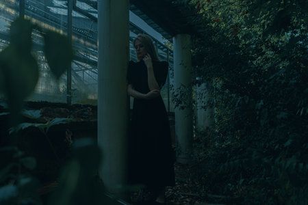 Beautiful Blond Girl Near Abandoned Houseplant At Gothic Park. Concept Of Depression and Loneliness. Looking For Supportの写真素材
