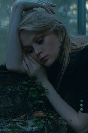 Dramatic Portrait Of Beautiful Woman In Gothic Style In Pose Of Depression And Fatigueの写真素材