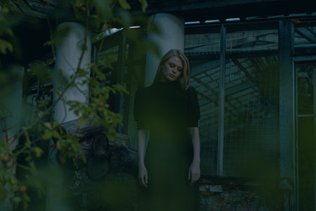 Beautiful Lady Near Abandoned Houseplant At Gothic Park. Sadness, Depression and Loneliness. noisy and dark imageの写真素材