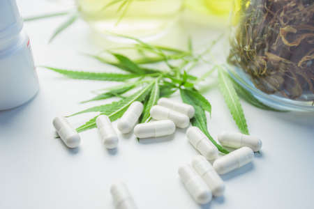 Capsule drugs made from marijuana ingredient. Concept alternative herbs for healing.の写真素材