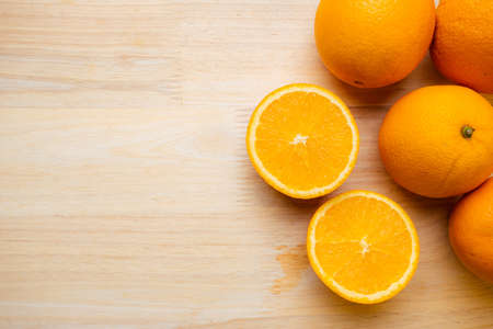 Orange fruit raw material for make juice. Orange on wooden table.の写真素材