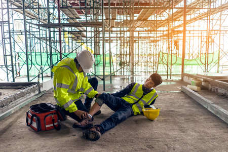 First aid support accident in site work, Builder accident fall scaffolding to the floor, Safety team help employee accident.の素材 [FY310166049854]