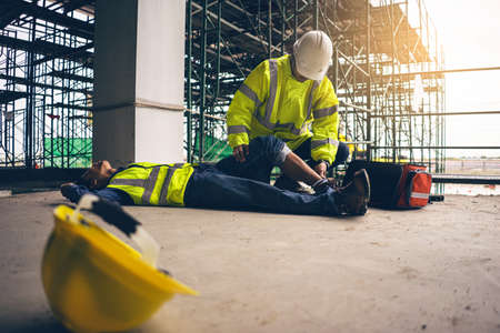 First aid support accident in site work, Builder accident fall scaffolding to the floor, Safety team...