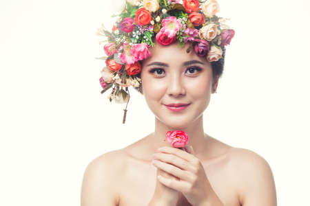 Portrait of beautiful young asian woman with flowers. Brunette woman with luxury makeup. Perfect...