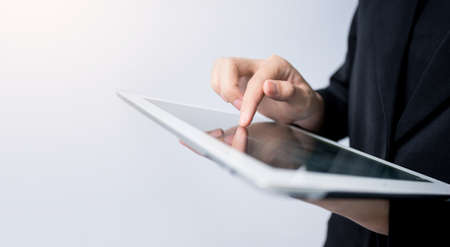 Business people use technology tablet for working isolate in soft grey background.の写真素材