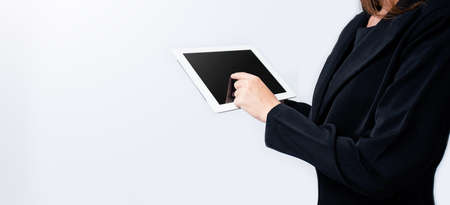 Business people use technology tablet for working isolate in soft grey background.の写真素材