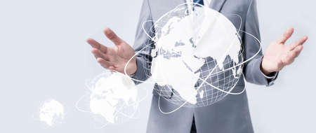 Businessman holding global data network and analyzing trend data and economic growth. Technology and business strategy. Digital marketing on interface hologram screen.の写真素材