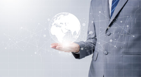 Businessman holding global data network and analyzing trend data and economic growth. Technology and business strategy. Digital marketing on interface hologram screen.の写真素材