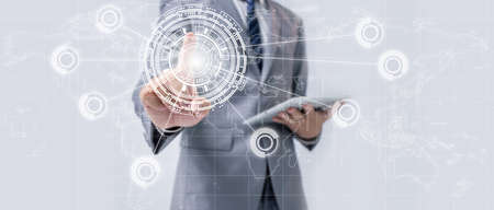 businessman touching virtual screen with world map, Businessman use interface and tablet for economic and connection in world map. Business strategy.の写真素材