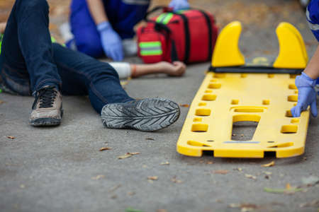 Stretcher preparing for support people accident on the road. Paramedic team first aid person accident lying on the road.の写真素材