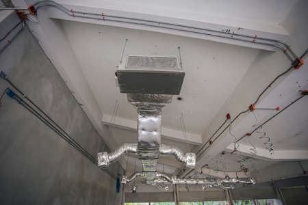 Ducting work for air conditioner ceiling type. Installation AC Ductwork in the construction site.の写真素材
